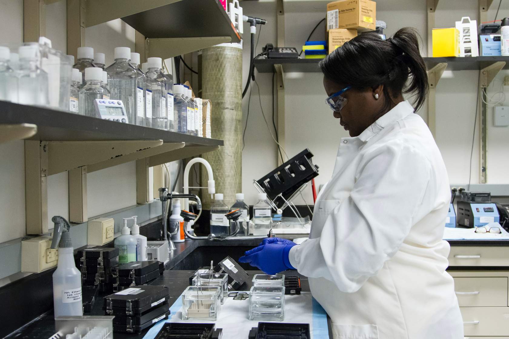 scientist in laboratory with a  microscope